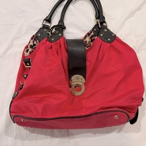Bright pink JPK Paris purse with leopard print interior